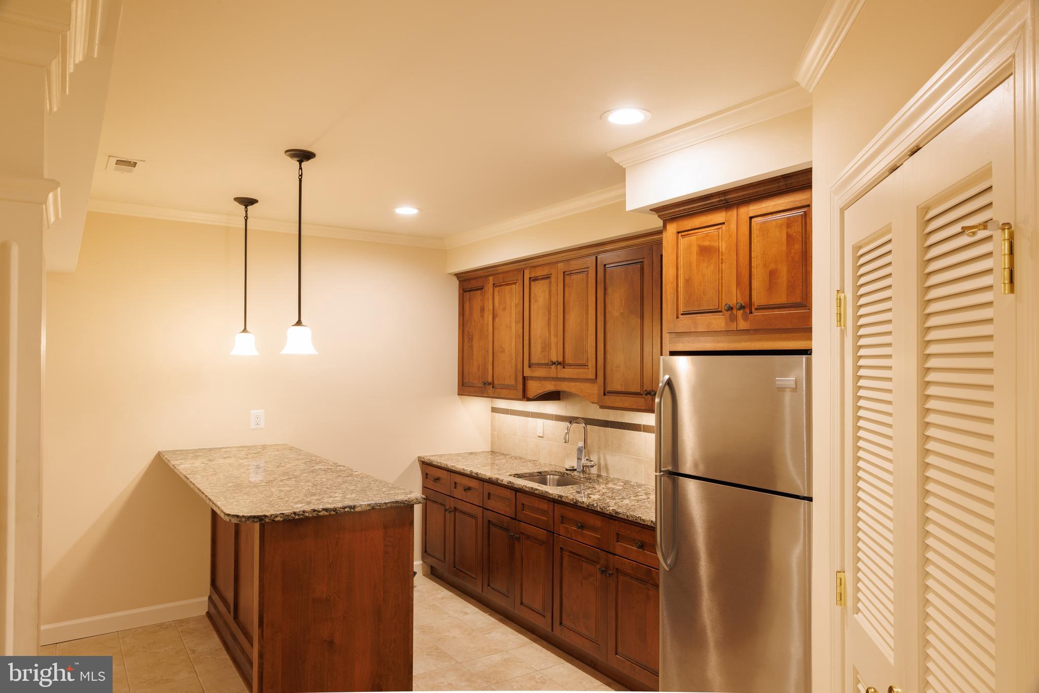 8623 James Creek Drive Springfield, VA 22152 - Photo 57 of 69 a kitchen with stainless steel appliances granite countertop a refrigerator a sink and a stove
