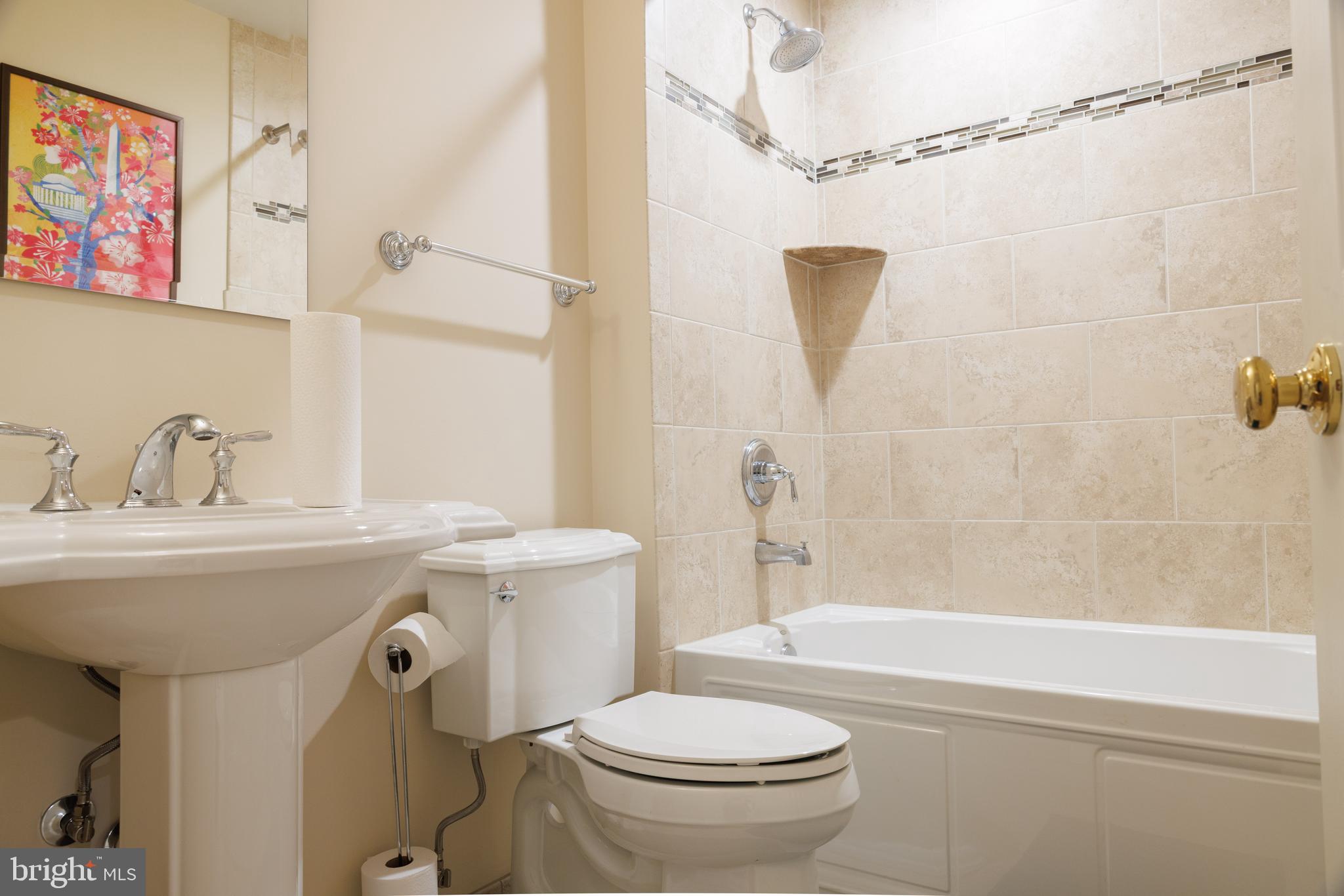 8623 James Creek Drive Springfield, VA 22152 - Photo 60 of 69 a bathroom with a sink a mirror a toilet and bathtub