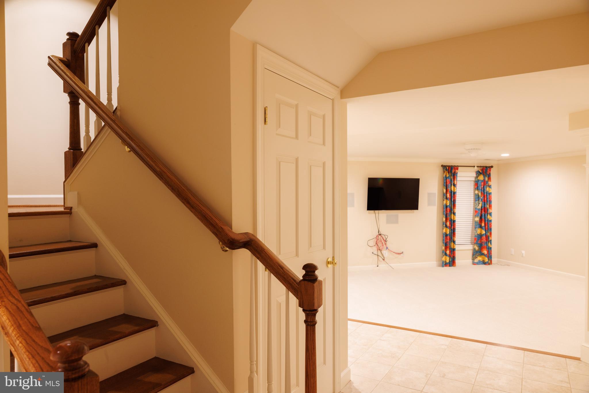 8623 James Creek Drive Springfield, VA 22152 - Photo 63 of 69 a view of a hallway with wooden floor and staircase
