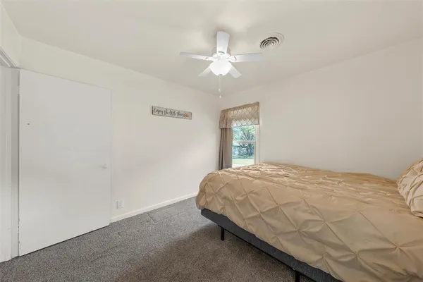a bed sitting in a room next to a window