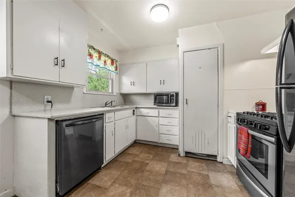 a kitchen with a refrigerator sink and stove
