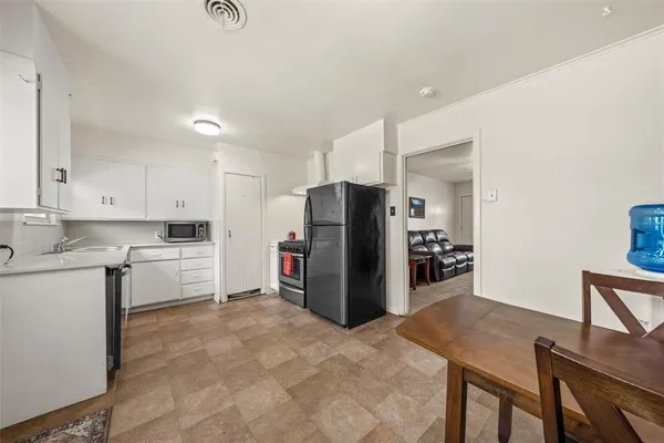 a kitchen with cabinets appliances and a window