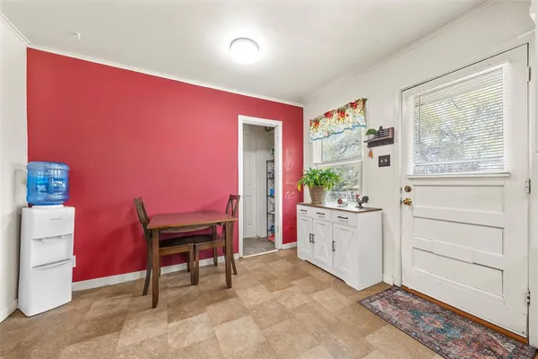 a kitchen with refrigerator and cabinets