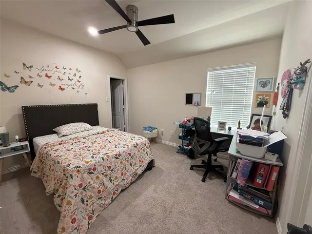 a bedroom with bed and a chandelier