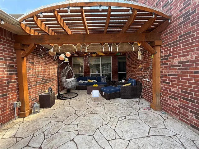 a view of a patio with table and chairs