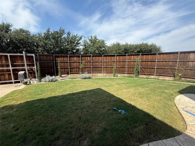 a backyard with swimming pool and green space