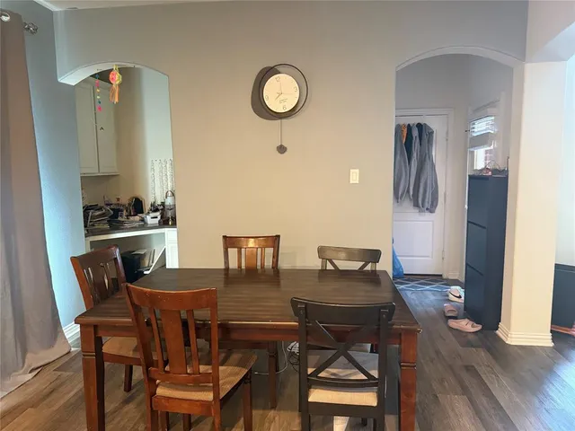 a dining room with furniture and wooden floor