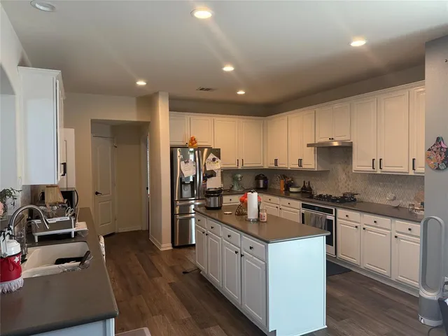 a kitchen with a sink stove and refrigerator
