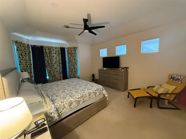 a bedroom with a bed and a television