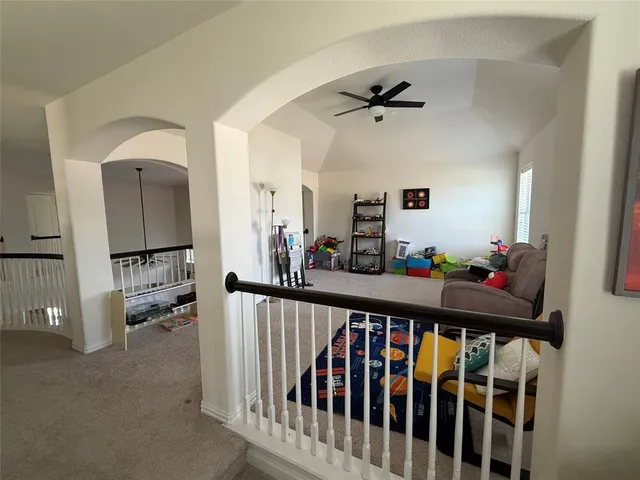 a view of a hallway to a livingroom with furniture