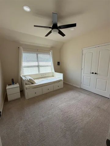 a view of room with stairs and a ceiling fan