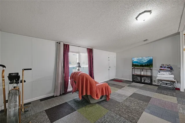 a living room with furniture gym equipment and a window