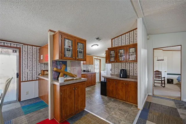 a kitchen with granite countertop a stove oven and refrigerator