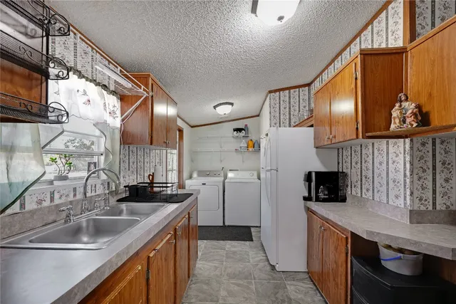 a kitchen with refrigerator and cabinets