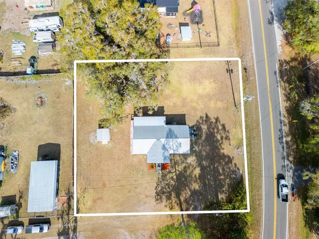an aerial view of residential house with outdoor space