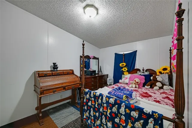 a bed room with two beds and a desk