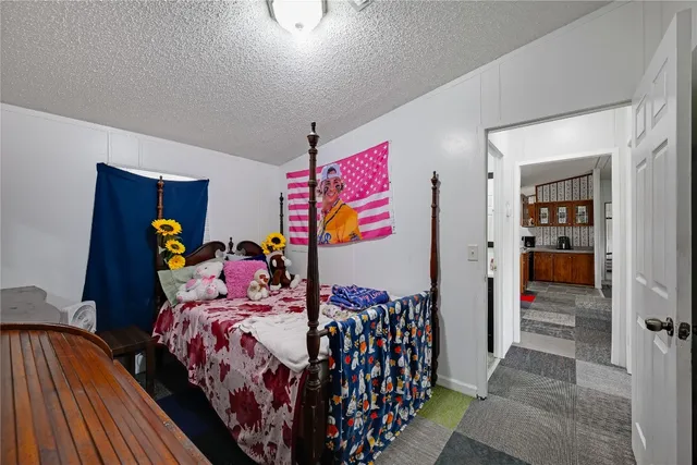 a bedroom with bed and wooden floor