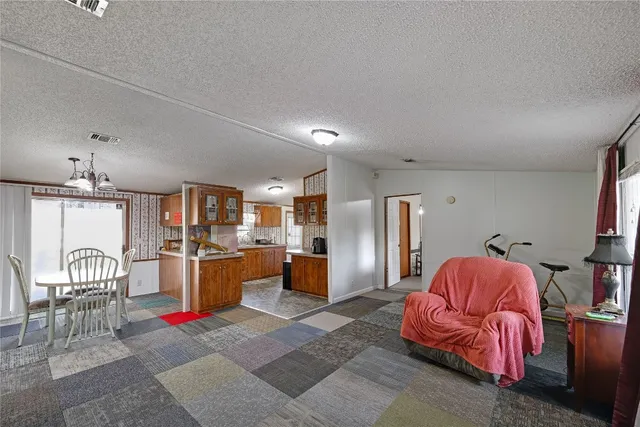 a living room with furniture a couch and chandelier