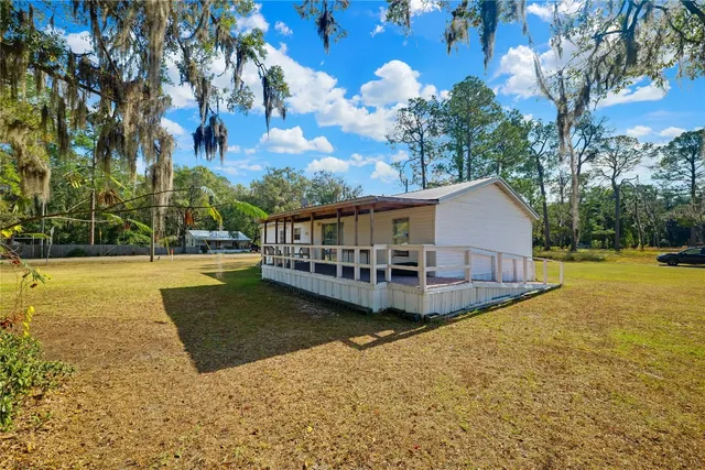 a view of a house with swimming pool and sitting area
