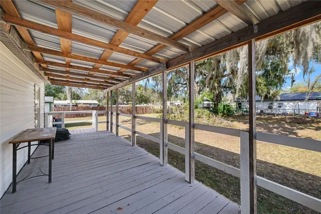 a view of a porch and wooden floor