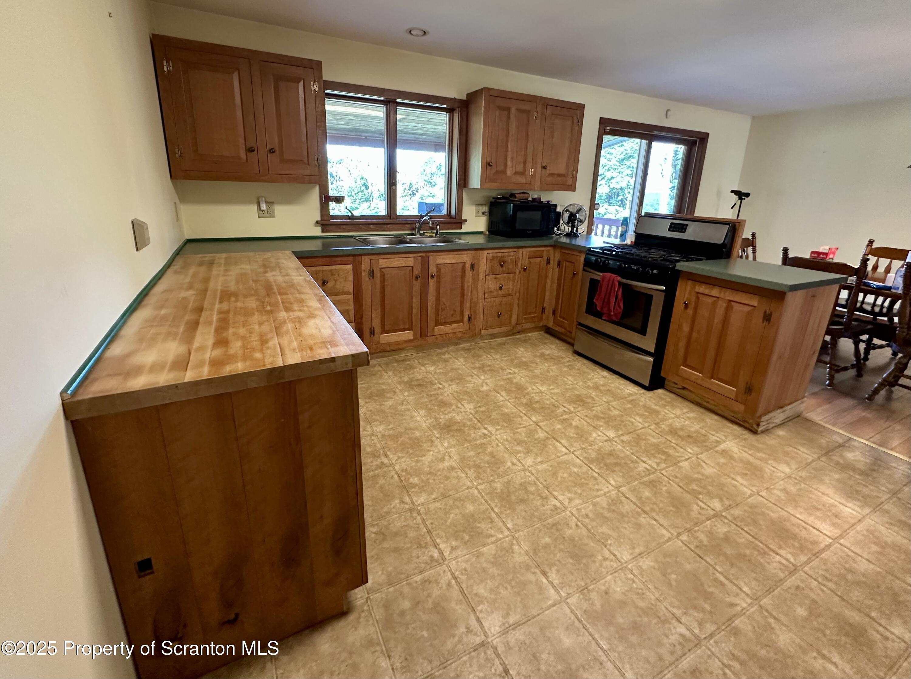 5290 Irish Hill Road Montrose, PA 18801 - Photo 16 of 67 a kitchen with sink window and cabinets