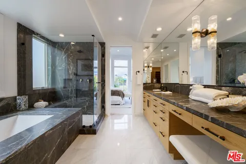 a spacious bedroom with a bed and a lamp