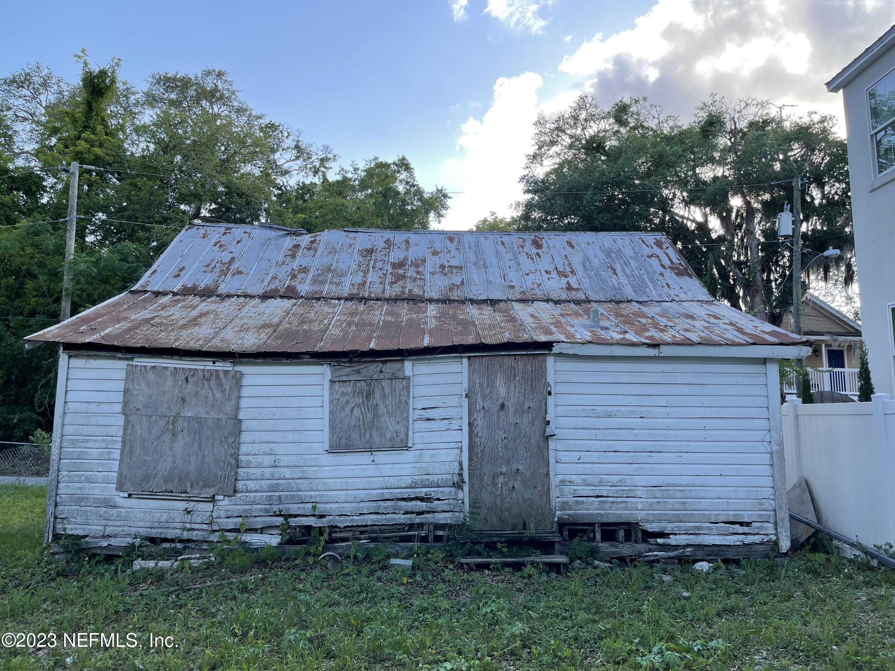 93 Oneida Street St. Augustine, FL 32084 - Photo 8 of 8 a view of wooden house with a yard and wooden fence