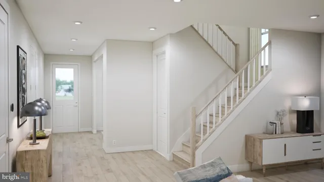 a view of entryway and hall with wooden floor
