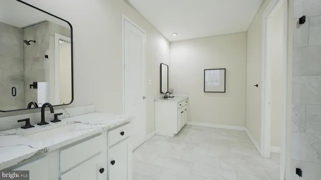 a bathroom with a double vanity sink mirror and shower