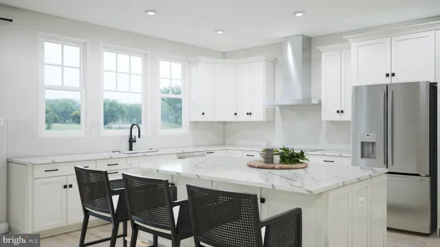 a kitchen with stainless steel appliances granite countertop a white cabinets and a refrigerator