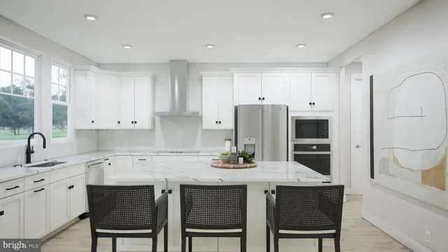 a kitchen with stainless steel appliances a sink and cabinets