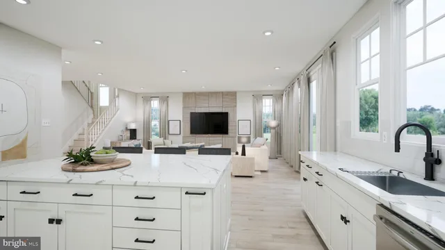 a large white kitchen with a large window and stainless steel appliances