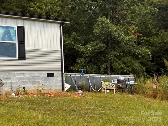 a view of a patio with table and chairs with wooden floor and fence