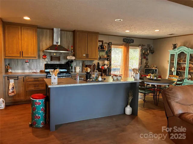 a kitchen with stainless steel appliances granite countertop a sink a stove and a refrigerator