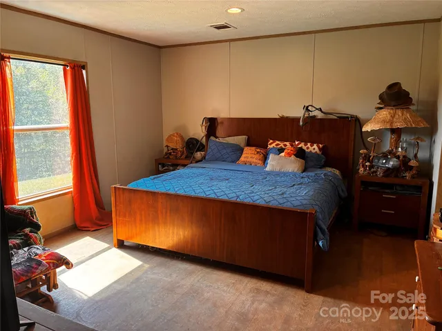 a bed room with two beds and a window