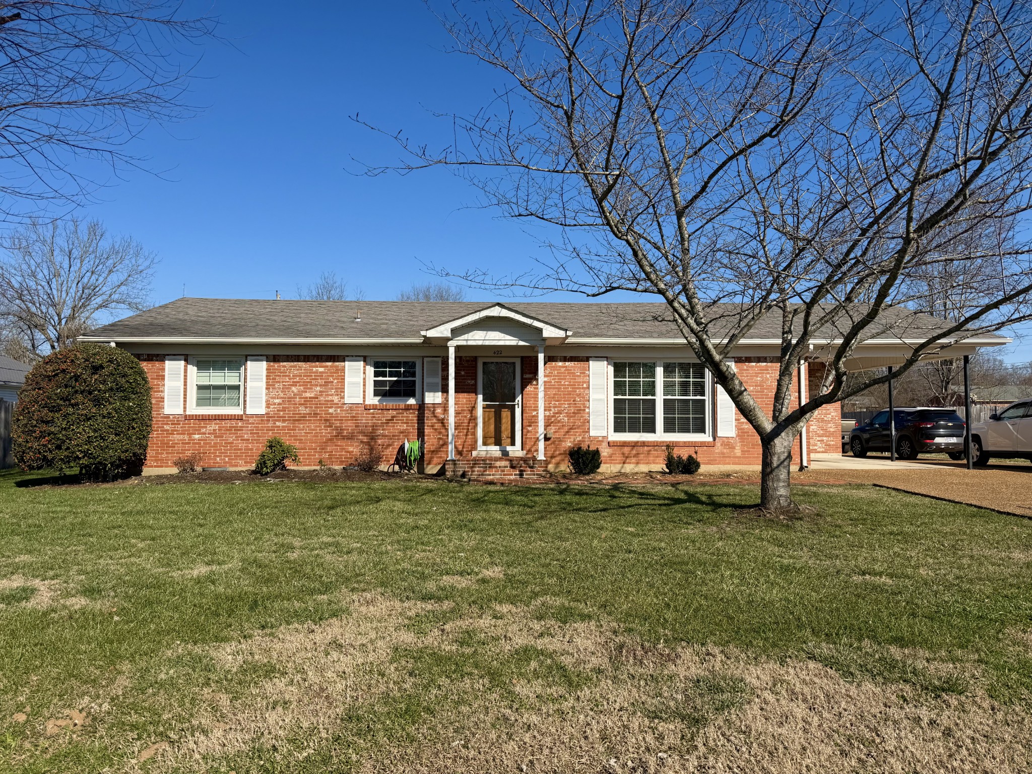 a front view of a house with a garden