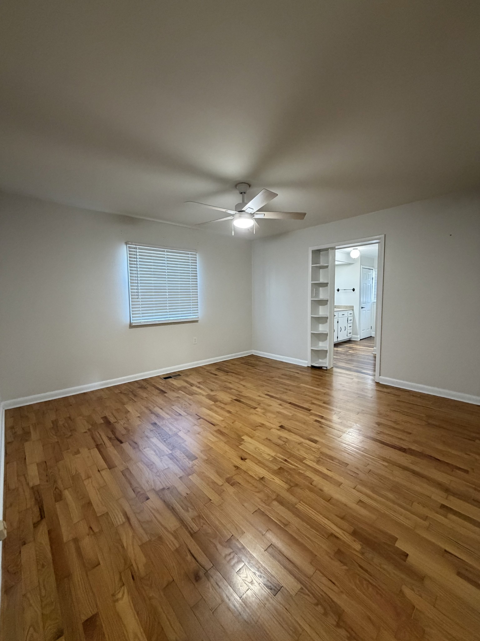 422 7th Street Lawrenceburg, TN 38464 - Photo 13 of 25 an empty room with wooden floor and windows