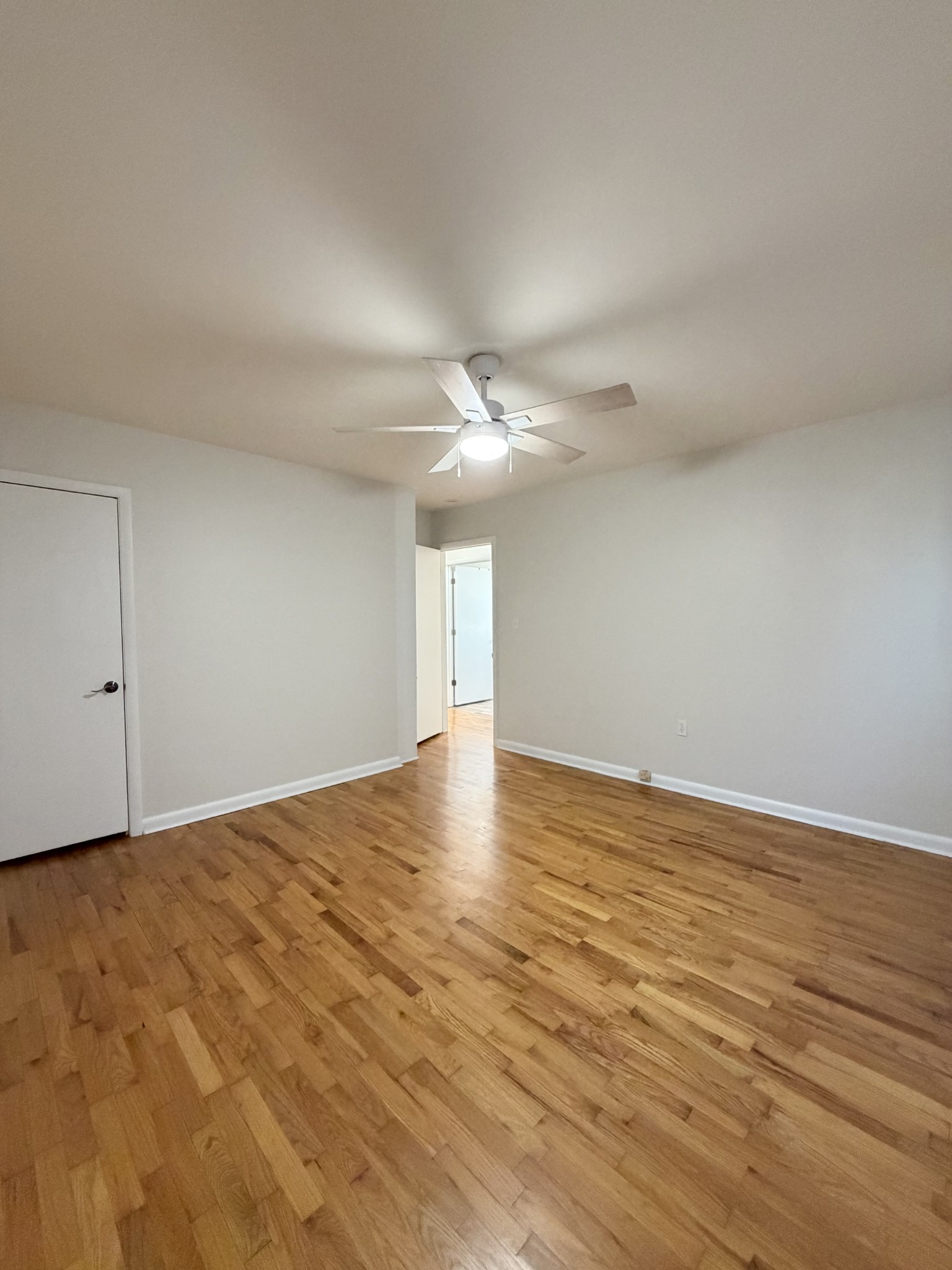 422 7th Street Lawrenceburg, TN 38464 - Photo 14 of 25 a view of an empty room with wooden floor and a ceiling fan
