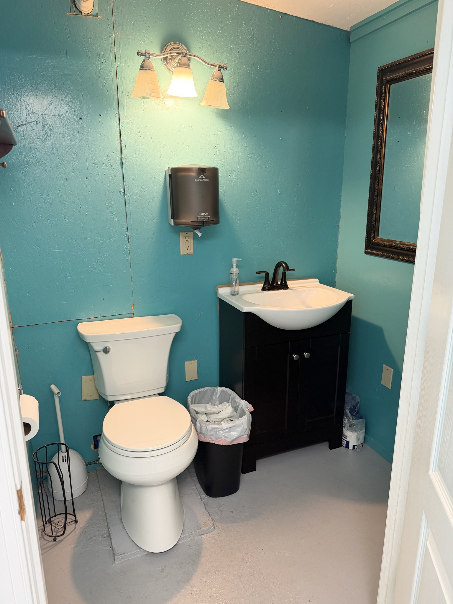 422 7th Street Lawrenceburg, TN 38464 - Photo 25 of 25 a bathroom with a toilet sink and mirror