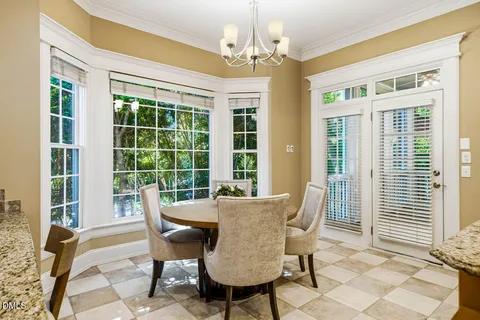 a kitchen with granite countertop a sink and a stove next to a window