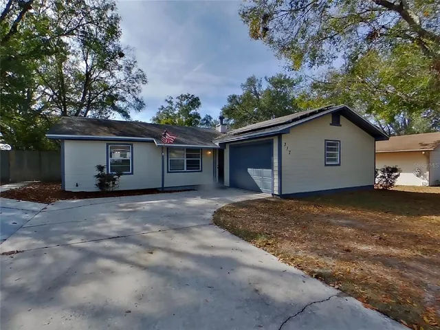 a view of a house with a yard and garage