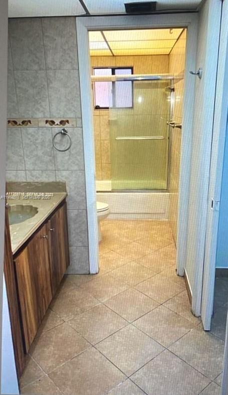 8420 Southwest 133rd Avenue Road, Unit 309 Miami, FL 33183 - Photo 14 of 22 a bathroom with a granite countertop shower and a sink