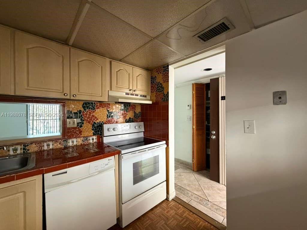 8420 Southwest 133rd Avenue Road, Unit 309 Miami, FL 33183 - Photo 19 of 22 a kitchen with stainless steel appliances granite countertop a refrigerator and white cabinets