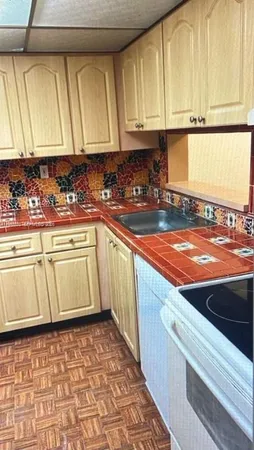 a kitchen with a sink and cabinets
