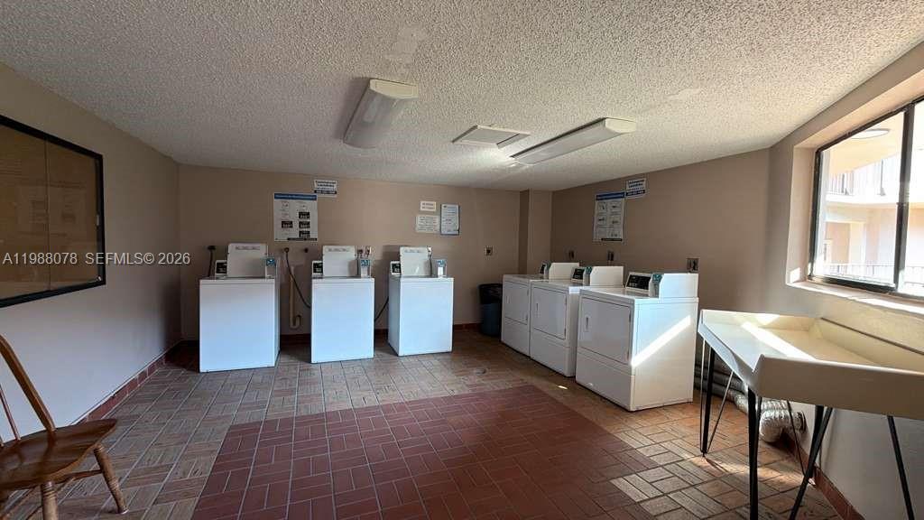 8420 Southwest 133rd Avenue Road, Unit 309 Miami, FL 33183 - Photo 22 of 22 a living room with furniture and a flat screen tv