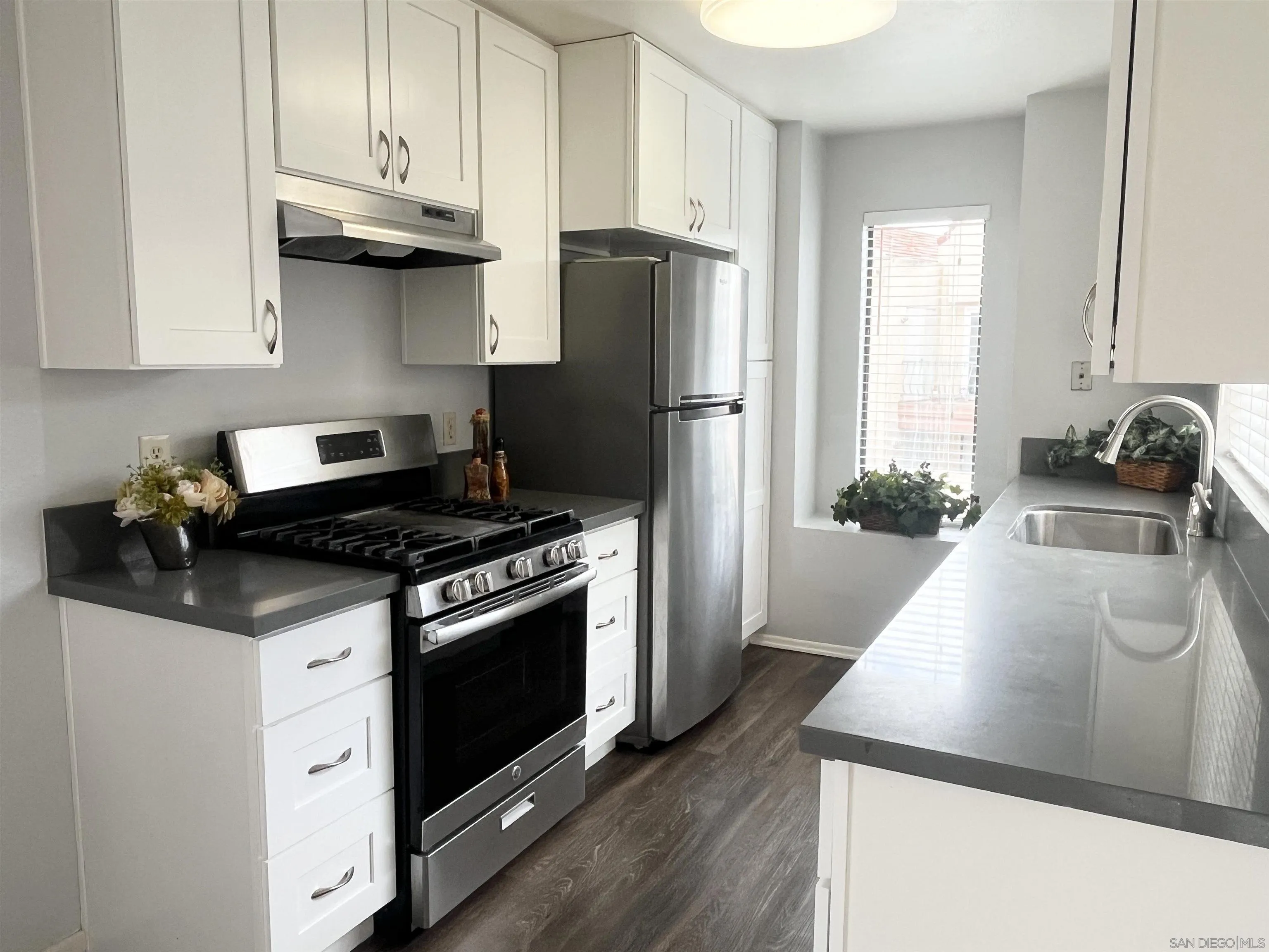 8365 Westmore Road, Unit 20 San Diego, CA 92126 - Photo 11 of 29 a kitchen with stainless steel appliances granite countertop a stove a refrigerator and a sink