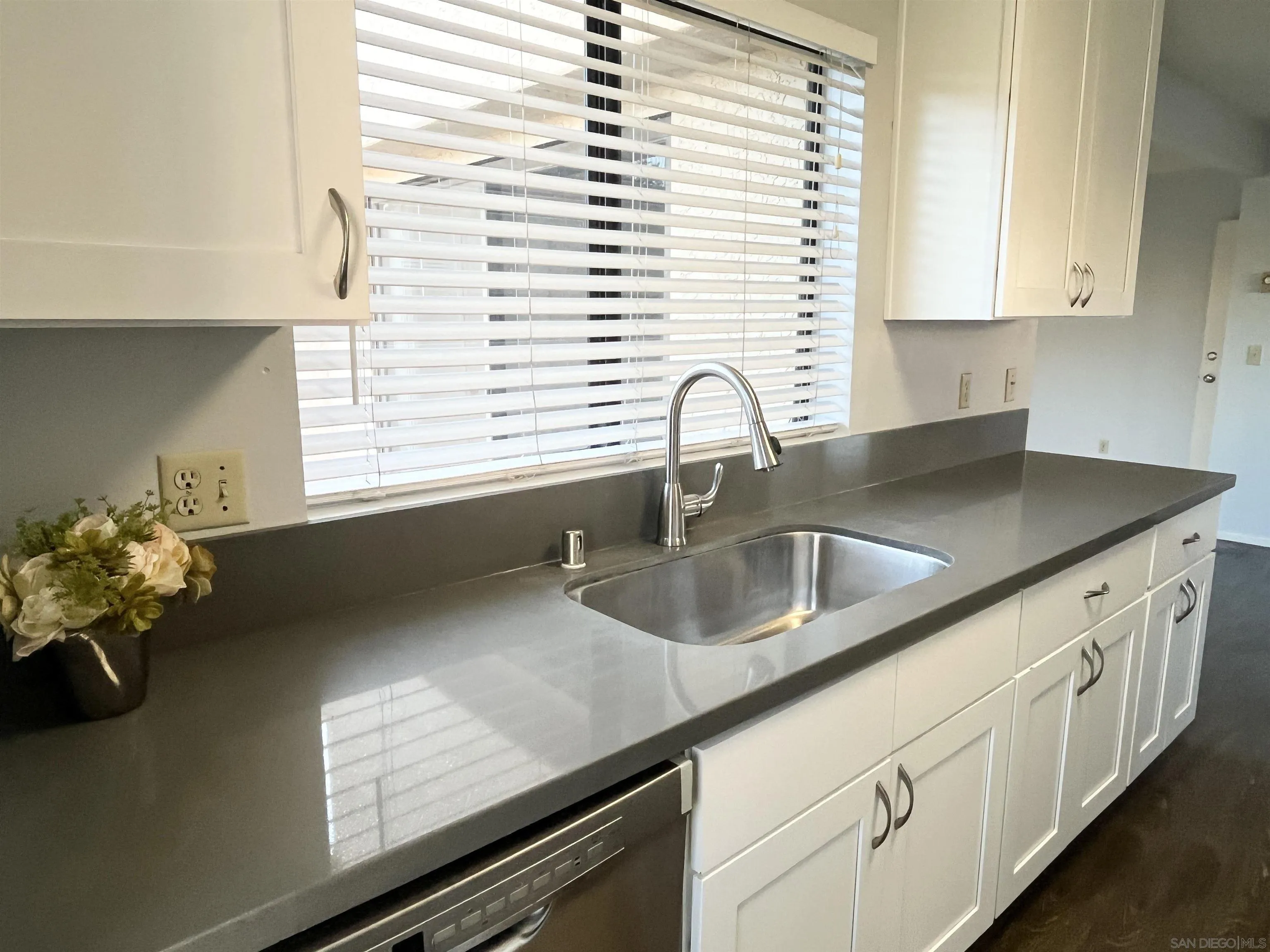 8365 Westmore Road, Unit 20 San Diego, CA 92126 - Photo 12 of 29 a kitchen with granite countertop a sink white cabinets and a granite counter tops