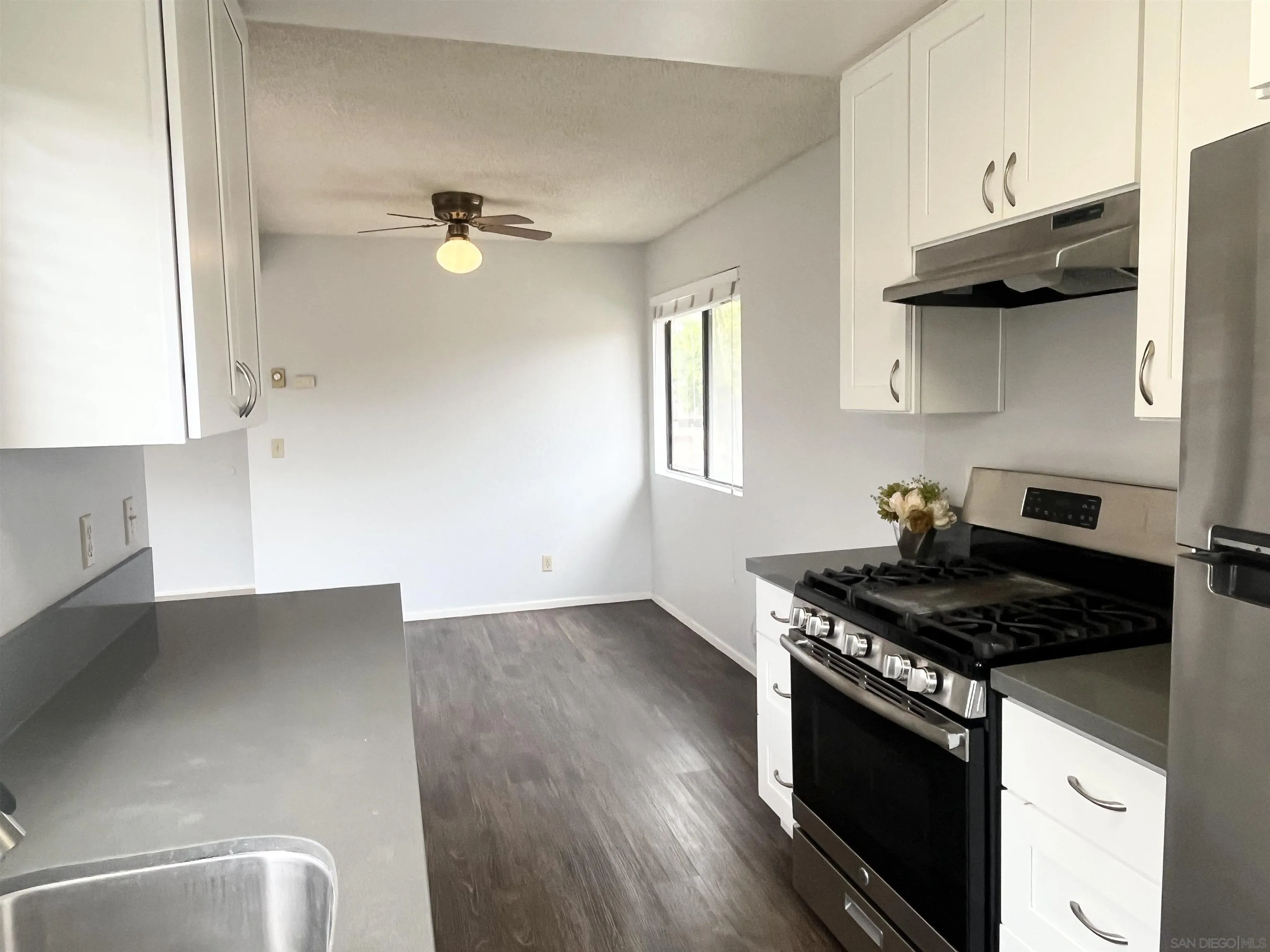 8365 Westmore Road, Unit 20 San Diego, CA 92126 - Photo 13 of 29 a kitchen with granite countertop a stove and a sink