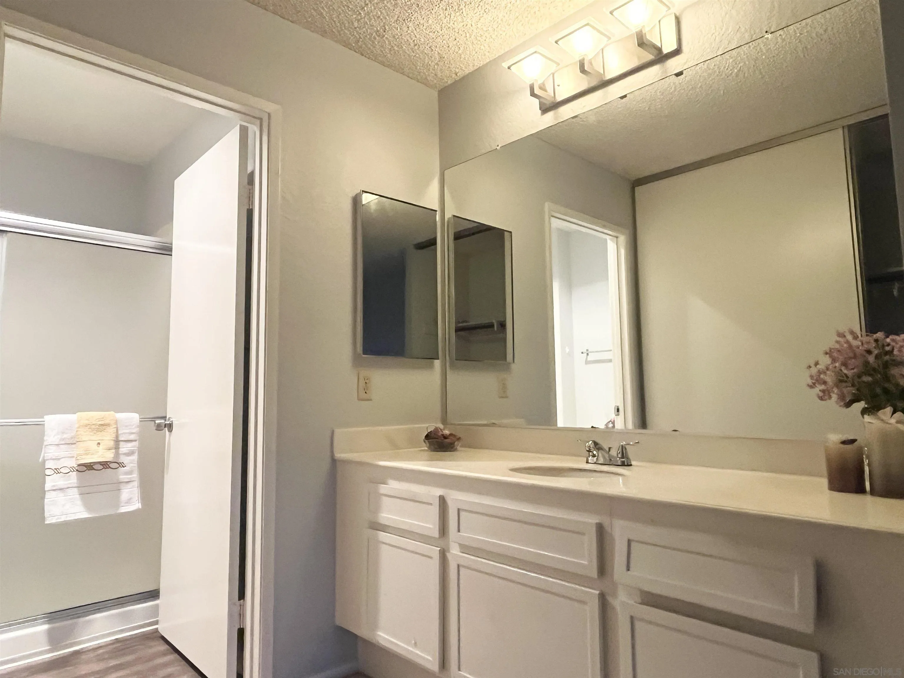8365 Westmore Road, Unit 20 San Diego, CA 92126 - Photo 16 of 29 a bathroom with a double vanity sink and mirror
