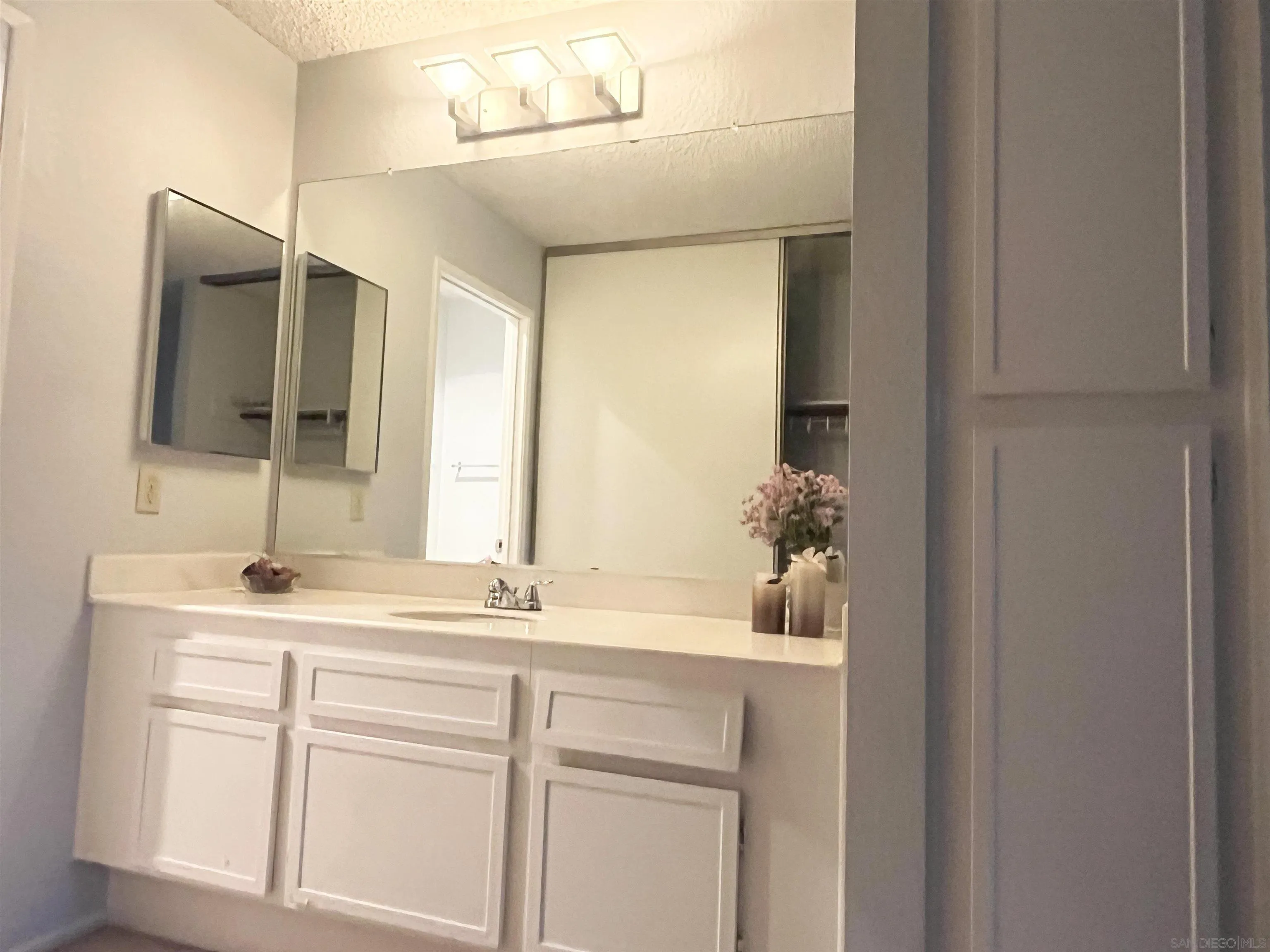 8365 Westmore Road, Unit 20 San Diego, CA 92126 - Photo 17 of 29 a bathroom with a sink and a mirror